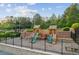 Community playground with swings, slides, and climbing structures surrounded by lush greenery and a secure fence at 440 Laurian Nw Way, Kennesaw, GA 30144