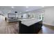 Open-concept rec room features a wet bar with marble countertop and seating for entertaining at 4992 Concert Ln, Marietta, GA 30066