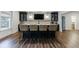 Finished basement bar with wood floors and four barstools at 4992 Concert Ln, Marietta, GA 30066