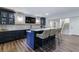 Finished basement bar with wood floors and a tiled backsplash at 4992 Concert Ln, Marietta, GA 30066