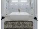 Bright bathroom with a large tub and spacious walk-in shower featuring marble-style tiling and gold hardware at 4992 Concert Ln, Marietta, GA 30066