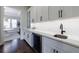Butler's pantry featuring white cabinets, stone countertops, wine refrigerator and hardwood flooring at 4992 Concert Ln, Marietta, GA 30066