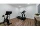 Home gym features a stationary bike, treadmill, and wood flooring at 4992 Concert Ln, Marietta, GA 30066
