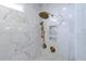 Shower features tiled walls, gold shower head and faucet, and recessed shelving at 4992 Concert Ln, Marietta, GA 30066