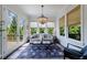Cozy sunroom with large windows, a comfortable seating area, and a chandelier at 4992 Concert Ln, Marietta, GA 30066