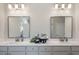Bathroom vanity with double sinks, modern fixtures, and decorative accents at 5315 Trescott Path, Cumming, GA 30028