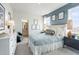 Light, bright bedroom with blue accent wall, full bathroom, and stylish decor at 5315 Trescott Path, Cumming, GA 30028