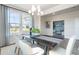 Open dining room with natural light, stylish seating, and views of a potential office space for modern living at 5315 Trescott Path, Cumming, GA 30028
