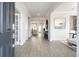 Bright entryway with luxury vinyl plank flooring and white trim, showcasing an open floor plan and modern design at 5315 Trescott Path, Cumming, GA 30028