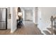 Inviting hallway with wood-look floors, stylish console table, and access to the staircase at 5315 Trescott Path, Cumming, GA 30028