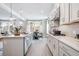 Open kitchen with a large island, pendant lights, and stainless steel appliances for a modern look at 5315 Trescott Path, Cumming, GA 30028
