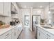 Modern kitchen features stainless steel appliances, white cabinets, and an open layout at 5315 Trescott Path, Cumming, GA 30028