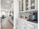 Modern kitchen boasts white cabinets, stainless steel appliances, and a sleek coffee bar at 5315 Trescott Path, Cumming, GA 30028