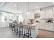 Stylish kitchen features a large island, pendant lighting, and stainless steel appliances at 5315 Trescott Path, Cumming, GA 30028