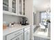 Bright kitchen features white cabinets, herringbone backsplash, and a convenient coffee station at 5315 Trescott Path, Cumming, GA 30028
