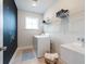 Laundry room featuring a washer and dryer, with a utility sink and chalkboard accent wall at 5315 Trescott Path, Cumming, GA 30028