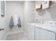 Functional laundry room featuring a modern washer, dryer, and ample storage solutions at 5315 Trescott Path, Cumming, GA 30028