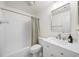 Bathroom featuring white cabinetry, marble countertops, and a shower-tub combo at 76 Forrest Pl, Atlanta, GA 30328