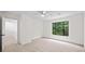 Bright bedroom with a ceiling fan, a large window with a view, and neutral carpet at 76 Forrest Pl, Atlanta, GA 30328