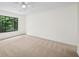 Spacious bedroom features neutral carpet and a large window view at 76 Forrest Pl, Atlanta, GA 30328