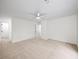 A well-lit, carpeted bedroom with white walls, a ceiling fan, and trim at 76 Forrest Pl, Atlanta, GA 30328