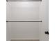A functional closet design featuring two black metal rods for hanging clothes with carpet flooring at 76 Forrest Pl, Atlanta, GA 30328