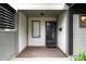 Close-up view of the home's front door with visible address number and secure screen door at 76 Forrest Pl, Atlanta, GA 30328