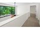 Upstairs landing boasts a big window and neutral carpet flooring at 76 Forrest Pl, Atlanta, GA 30328