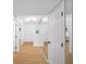 Hallway with a mirrored wall, white doors, and neutral flooring provides access to various rooms at 76 Forrest Pl, Atlanta, GA 30328