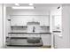 Kitchen featuring white cabinets, black countertops and modern fixtures at 76 Forrest Pl, Atlanta, GA 30328