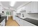 Bright kitchen features white cabinets, black countertops, and stainless steel appliances at 76 Forrest Pl, Atlanta, GA 30328