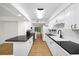 Spacious eat-in kitchen boasts white cabinets, granite countertops, and wood flooring at 76 Forrest Pl, Atlanta, GA 30328