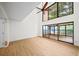 Living area with large windows, light wood floors, and access to the screened-in porch at 76 Forrest Pl, Atlanta, GA 30328