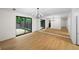 Spacious living room with new flooring, modern light fixture, and a sliding door to outdoor area at 76 Forrest Pl, Atlanta, GA 30328