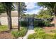 Landscaped pool entrance with a stone building and shaded walkway, creating a welcoming atmosphere at 76 Forrest Pl, Atlanta, GA 30328