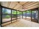 Bright sunroom with tiled flooring and windows offering serene views of the surrounding greenery at 76 Forrest Pl, Atlanta, GA 30328