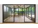 Enclosed sunroom with tiled floors, multiple windows, and ceiling fan for year-round enjoyment at 76 Forrest Pl, Atlanta, GA 30328