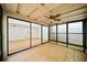 Enclosed sunroom with ceiling fan, neutral tile floor and view to the main living area at 76 Forrest Pl, Atlanta, GA 30328