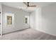 Bright bedroom with plush carpeting, a ceiling fan, and natural light streaming through the windows at 988 Mcdaniel Sw St, Atlanta, GA 30310