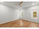 Bright bedroom with hardwood floors, ceiling fan, and natural light from two windows at 988 Mcdaniel Sw St, Atlanta, GA 30310