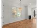 Open dining room featuring hardwood floors, a modern fireplace, and elegant chandelier at 988 Mcdaniel Sw St, Atlanta, GA 30310