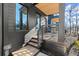 A modern home's covered porch with wooden decking and sleek metal railing details at 988 Mcdaniel Sw St, Atlanta, GA 30310