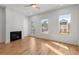 Bright living room with hardwood floors, a modern fireplace, and lots of natural light at 988 Mcdaniel Sw St, Atlanta, GA 30310