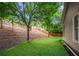 Spacious backyard featuring a gentle slope and a perimeter fence for added privacy at 998 Regal Hills Ln, Mableton, GA 30126