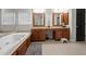 Bright bathroom featuring a soaking tub, double vanity, and neutral tile flooring at 998 Regal Hills Ln, Mableton, GA 30126