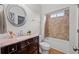 Bathroom featuring a tub-shower combo, a granite-topped vanity and a round mirror at 998 Regal Hills Ln, Mableton, GA 30126