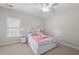 Well-lit bedroom featuring carpet flooring, a window, and a ceiling fan at 998 Regal Hills Ln, Mableton, GA 30126
