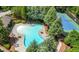 Community pool and tennis courts surrounded by lush greenery and mature trees at 998 Regal Hills Ln, Mableton, GA 30126