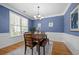 Well-lit dining area featuring wood floors, table, and chair set, complemented by elegant wall decor at 998 Regal Hills Ln, Mableton, GA 30126