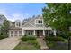 Charming home showcasing a covered front porch, beautiful landscaping, and a two-car garage at 998 Regal Hills Ln, Mableton, GA 30126